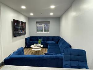 a living room with a blue couch and a table at Lovely Studio in Selly Oak 10 mins from city! in Birmingham