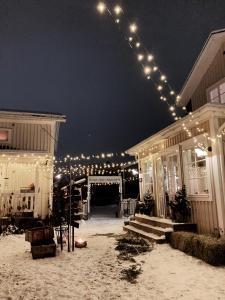 an outdoor wedding with lights on a house at Pensionatet in Piteå