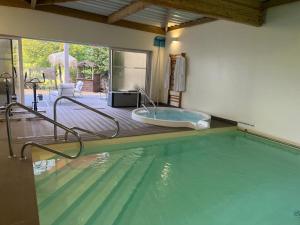 a large swimming pool with a tub in a house at RESIDENCE MONTANA in Cholet