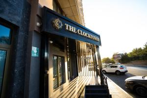 a building with a sign that reads the clociation at The Clocktower Hotel in Baku