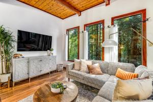 a living room with a couch and a table at Tree Tops Bungalow in Guerneville