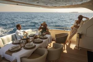 a group of people sitting around a table on a boat at EssoEss Boat - Five Star - Exclusive use in Palma de Mallorca