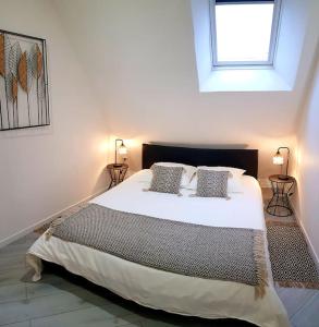 a bedroom with a large white bed with two pillows at Nalan Johannisien, Maison piscine chauffée-Spa, Paris CDG-Disney in Jagny-sous-Bois +41 photos