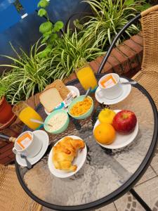 a table with plates of food and fruit on it at Hotel ATEPSA in Buenos Aires