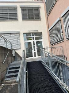 a staircase leading up to a building with a door at 3 Bett Zimmer in Ramstein-Miesenbach