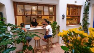 a group of people standing at a counter in a restaurant at Veranera Hostel in Estepona