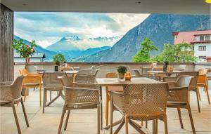 a restaurant with tables and chairs and a view of mountains at Beautiful Apartment In Zams With Wifi in Zams