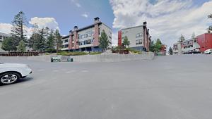 a white car parked in a parking lot with buildings at Spacious 2 BR Units at 1849 Condos with FREE Pool, Parking & Wifi in Mammoth Lakes