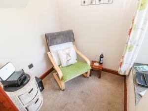 krzesło z poduszką w pokoju w obiekcie Glenridding Cottage w mieście Warcop