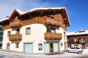 a building with wooden balconies on top of it at Casa Meta in Livigno