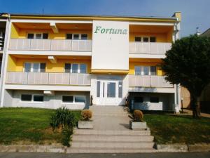 a building with a forino sign on the side of it at Penzion Fortuna Dudince in Dudince