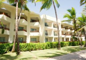an exterior view of a resort with palm trees at Impressive Punta Cana - All Inclusive in Punta Cana