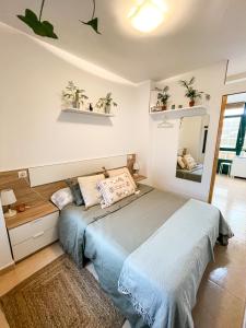 una camera con un letto e uno specchio di Apartamentos Sapoconcho by ALÔGA a Cee
