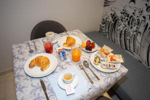 una mesa con platos de desayuno. en Odissea Residence e Rooms, en Santa Maria di Castellabate
