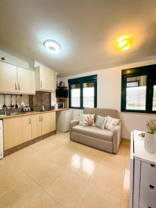 a living room with a couch and a kitchen at Apartamentos Sapoconcho by ALÔGA in Cee +18 photos