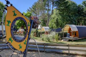 a playground at a park with a mirror at Team Holiday - Camping de l'Etang du Pays Blanc in Guérande
