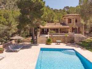 a house with a swimming pool in front of a house at Finca Binifarda Dor in Felanitx