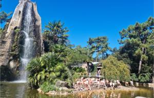 a group of people in the water in front of a waterfall at 1 Bedroom Stunning Home In Dolus-dolron in Dolus d'Oléron