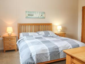 Un dormitorio con una cama con dos mesitas de noche y dos lámparas. en The Old Dairy, en Clapham