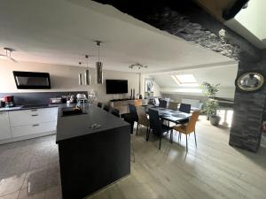 a kitchen and dining room with a table and chairs at Le 3 de Coeur Annecy in Annecy