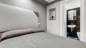 A bed or beds in a room at Scipioni Best Rooms