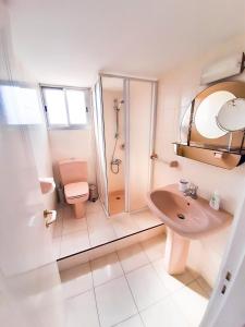 a bathroom with a toilet and a sink and a shower at Samson Sea Breeze, 3bed sleeps 6, free WiFi in Limassol