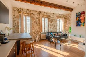 a kitchen and living room with a stone wall at Very Nice 58m Close To The Old Port in Marseille