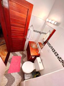 a small bathroom with a toilet and a sink at Residencial Bem-te-vi in Jericoacoara