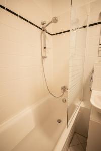 a bathroom with a shower and a tub and a sink at Wunderschön gepflegter Altbau, Aufzug in Chemnitz