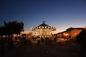 a merry go round in a town square at night at Le Tau in Saintes-Maries-de-la-Mer