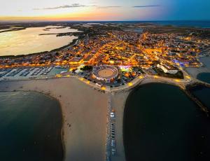 an aerial view of a city at night at Le Tau in Saintes-Maries-de-la-Mer +39 photos