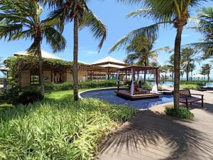 a resort with a playground and palm trees at Golf Ville Resorts Residence 3 Suítes, Porto das Dunas in Aquiraz