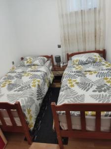 - deux lits assis l'un à côté de l'autre dans une pièce dans l'établissement Apartman David-Dražice, à Dražice