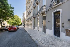 a street with cars parked on the side of a building at Luxury Casal Ribeiro I by Innkeeper in Lisbon