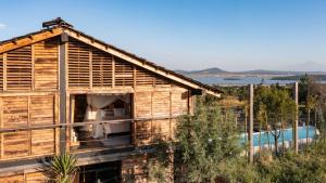 a wooden house with a pool in the background at Japoneza Retreat Nakamura 