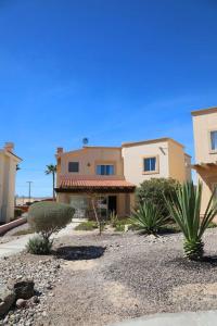 a house with some plants in front of it at Family House - The Village in Las Conchas #19 in Las Conchas