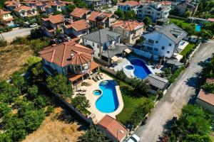 an aerial view of a house with a swimming pool at Hot tub-Fireplace-Pets-Sleeps 11-Bbq-Pool-Parking in Dalyan