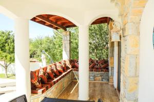 an outdoor patio with couches on a house at Hot tub-Fireplace-Pets-Sleeps 11-Bbq-Pool-Parking in Dalyan