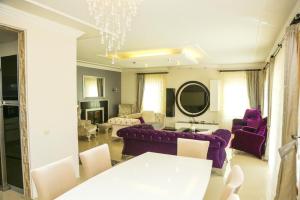 Stunning 4-Bedrooms Villa in Dalyan Turkey في داليان: غرفة معيشة بأثاث أرجواني وثريا