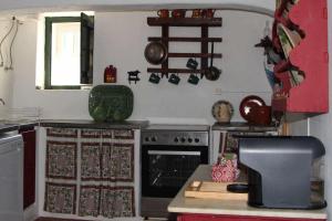 a kitchen with a stove and a counter top at Casa das Moles in Évora