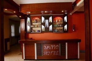 a bar in a room with orange walls at Mujjo Hotel Kajjansi in Kampala