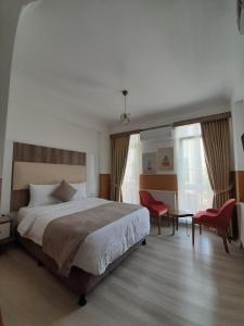 a bedroom with a bed and a table and chairs at Sun Bella Konaklama in Kırklareli