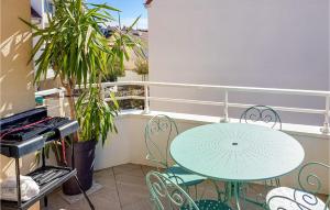 a table and chairs on a balcony with a keyboard at Amazing Apartment In Triel-sur-seine With 2 Bedrooms And Wifi in Triel-sur-Seine