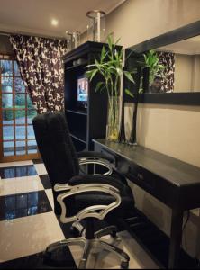 a desk and a chair in a room at Little Eden Guest Lodge in Vanderbijlpark