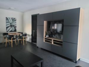a living room with a table and a black cabinet at Haus Karina in Bad Mitterndorf