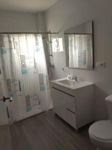 a bathroom with a sink and a shower curtain at El Recuerdo in Arcos de la Frontera