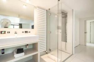 ein Badezimmer mit Glasdusche und Waschbecken in der Unterkunft Villa Alesia in Paris + 42 Fotos