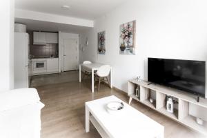 a living room with a large flat screen tv at Apartamento San Juan in El Puerto de Santa María
