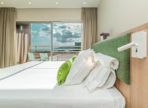 a bedroom with a bed with a large window at The Pearl Troia in Troia +47 photos