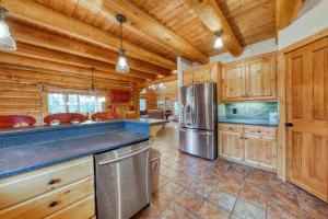 a kitchen with wooden cabinets and a stainless steel refrigerator at Woodland Wonder in Brian Head